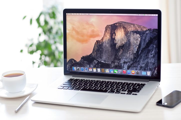 MacBook Pro with OS X Yosemite is on the table
